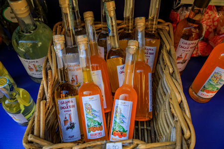 Manarola, Italy - June 2 2022: Bottles of traditional Cinque Terre arancino orange liqueur and grappa Italian brandy for sale in an old town gift shopのeditorial素材