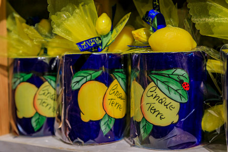 Manarola, Italy - June 2, 2022: Souvenir mugs filled with soap scented with traditional Ligurian lemons on display for sale at an old town gift shopのeditorial素材