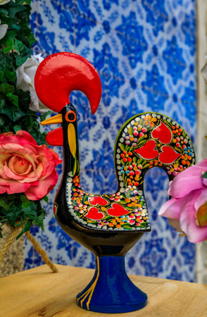 Porto, Portugal - May 29, 2018: Statuette of the traditional Portuguese Barcelos Rooster or Galo de Barcelos symbol of Portugal with azulejo tiles in the background at a souvenir shopのeditorial素材