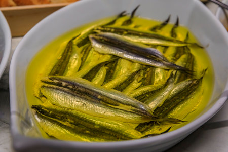 Traditional Spanish pintxos of anchovies marinated in vinegar in a dish on display in a restaurant, San Sebastian Donostia, Basque Country, Spainの写真素材
