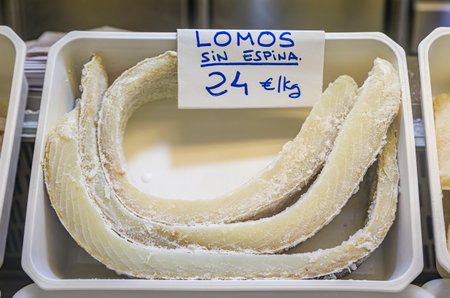 Dried pieces of salted cod or bacalao, traditional Spanish delicacy for sale at a local market in...