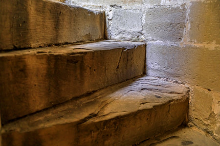 Olite, Spain - June 23, 2021: Worn steps of the spiral staircase in the gothic palace of the Kings of Navarre or Royal Palace of Olite in Navarraのeditorial素材