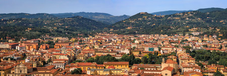 Aerial view of city skyline with the Tuscan mountains and city terracotta red roofs from Santa Maria del Fiore Duomo Cathedral dome, Florence, Italyの写真素材