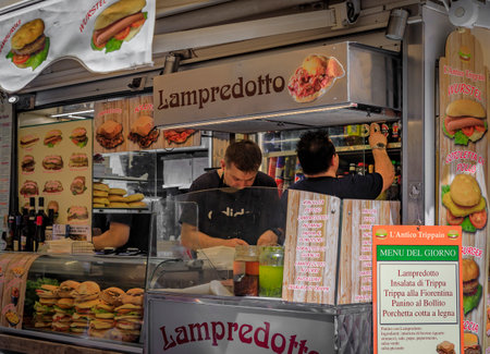 Florence, Italy - June 04, 2022: Classic tripe sandwich or lampredotto panini sold at a street food vendor stall in Centro Storico historic centerのeditorial素材