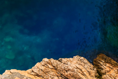 Turquoise water of the Mediterranean Sea viewed from the cliffs above in Nice, South of France or the French Rivieraの写真素材