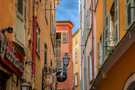 Nice, France - May 25, 2022: Restaurants and bars on a narrow street in the Old Town, Vieille Ville, French Rivieraのeditorial素材