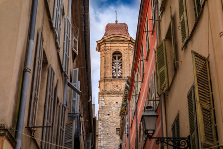Bell tower of the Jesuits chapel or Church of Saint Jacques le Majeur and traditional mediterranean house facades in the streets Old Town Nice, Franceの写真素材