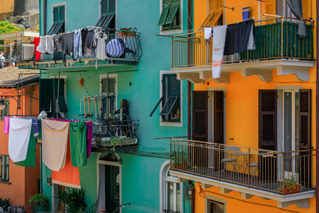 Traditional colorful houses on a narrow street in old town of Manarola in Cinque Terre on the Mediterranean Sea, Italyの写真素材