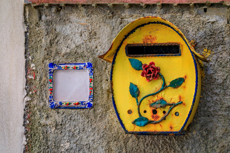 Traditional ornate and colorful antique mailbox in a street in the old town of Riomaggiore in Cinque Terre on the Mediterranean Sea, Italyの写真素材