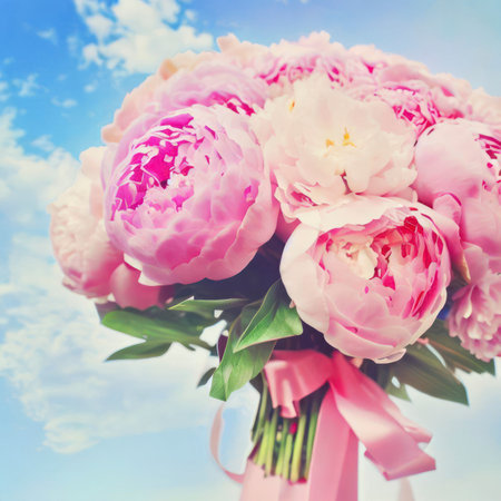 Bouquet of pastel pink spring flowers peonies and roses against a blue sky with clouds, wedding, Easter, Mother's day, vintage style, generative aiの素材