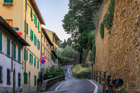 Medieval Renaissance stone city wall along a narrow road in Oltrarno Santo Spirito area of Centro Storico or Historic Centre of Florence, Italyの写真素材