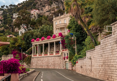 Bougainvillea blossom framing a coastal road on the French Riviera in picturesque medieval seaside Villefranche sur Mer, South of Franceの写真素材