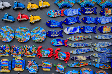 Manarola, Italy - June 01, 2022: Colorful souvenir magnets with views of Cinque Terre villages on display at an old town gift shopのeditorial素材