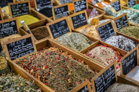 Exotic flavored salts with herbs and spices for sale at a local covered provencal farmers market hall in old town or Vieil Antibes, South of Franceの写真素材