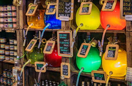 Menton, France - May 26, 2023: Colorful rum, vodka and tequila gourmet fruity cocktails dispensed from bulk bottles at an artisanal store in Old Townのeditorial素材