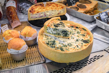 Quiche with spinach, quiche lorraine with ham and cheese, cheese souffle at a farmers market in the Old Town Menton, French Riviera, South of Franceの写真素材