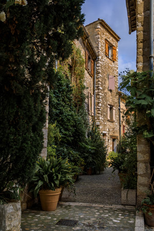 Traditional old stone houses on a street in the medieval town of Saint Paul de Vence, French...