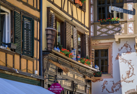 Strasbourg, France - May 31, 2023: Ornate facades of Alsatian winstub restaurants in traditional ancient half timbered houses in the historic centerのeditorial素材