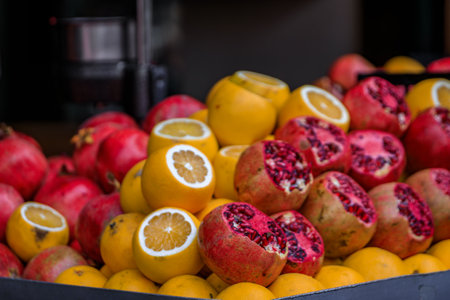 Fresh pomegranate and orange fruit on display at at juice stand of a traditional street seller in Eminonu Istanbul, Turkeyの写真素材