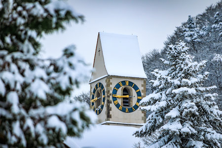 Winter wonderland in Stallikon, Switzerland, a picturesque view of a snow covered church tower...