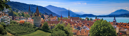 Panorama of Zug, Switzerland with the town's picturesque medieval architecture, lush vineyards,...