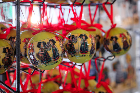 Colmar, France - June 5, 2023: Display of Christmas ornaments with traditional Alsatian decorative designs for sale at a souvenir shop in the old townの写真素材