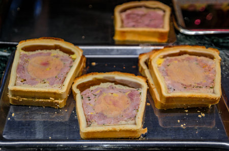 Foie gras or duck liver pate in a pastry, meat pie at a farmers market at an artisanal bakery in the historic center of Strasbourg, Alsace, Franceの写真素材