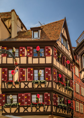 Ornate traditional half timbered houses with blooming flowers along the canals, Little Venice district in Colmar, picturesque village in Alsace Franceの写真素材
