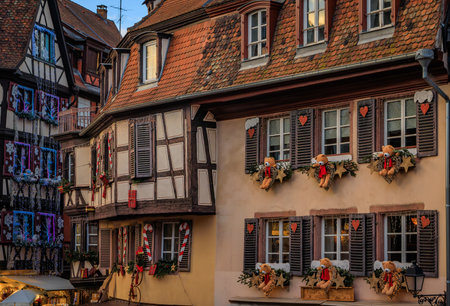Traditional old half timber houses decorated with red and gold ornaments and teddy bears at the famous Colmar Christmas Market, Franceの写真素材
