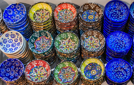 Ornate handmade Turkish ceramic Iznik pottery plates with floral Islamic patterns and reliefs in Ottoman style at the Grand Bazaar in Istanbul, Turkeyの写真素材
