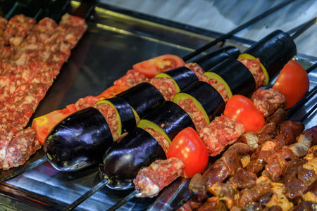 Skewers of fresh ready made Turkish kebabs with ground meat, eggplant and tomatoes, displayed for purchase at a restaurant in Istanbul, Turkeyの写真素材