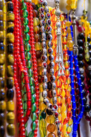 Colorful beaded bracelets with evil eye charms and gemstones on display for sale at a bustling...