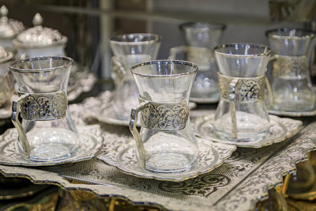Display of traditional Turkish tea and coffee sets with intricate patterns on a decorative tray at a...