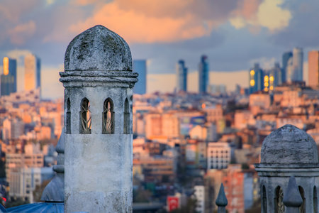 Dramatic sunset over the historic Suleymaniye Mosque domes, with the expansive cityscape and the bustling Golden Horn strait in Istanbul, Turkeyの写真素材