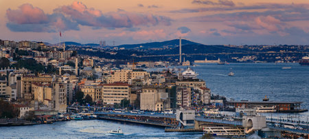 Panoramic view of the Bosphorus Strait and Bridge, bathed in golden hour sunset light under dramatic clouds, the iconic cityscape of Istanbul, Turkeyの写真素材