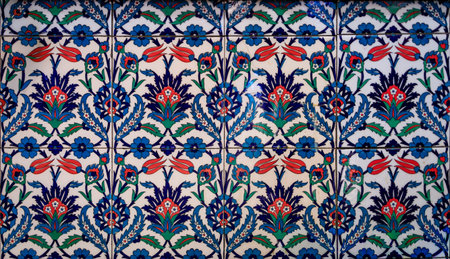 Ornate blue and red handmade Turkish Iznik mosaic tiles with floral Islamic patterns in a...