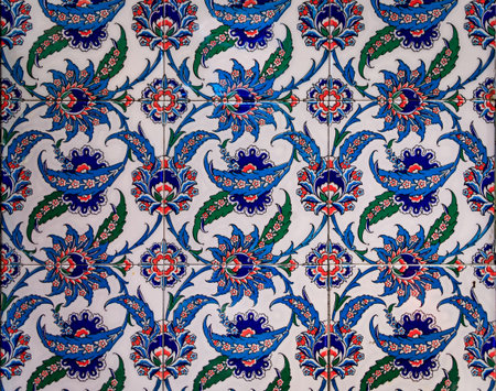 Ornate blue and red handmade Turkish Iznik mosaic tiles with floral Islamic patterns in a...