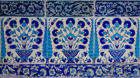 Ornate blue and red handmade Turkish Iznik mosaic tiles with floral Islamic patterns in a...