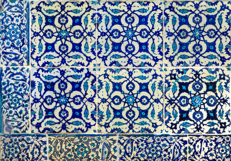Ornate blue and red handmade Turkish Iznik mosaic tiles with floral Islamic patterns in a...