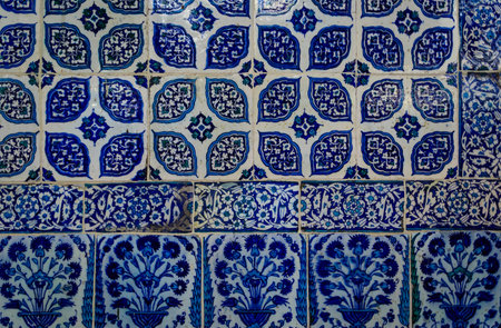 Ornate blue and red handmade Turkish Iznik mosaic tiles with floral Islamic patterns in a...