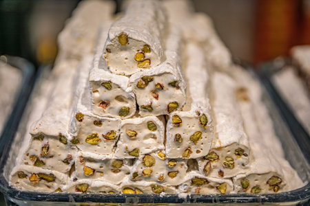 Selection of turkish delight nougat with pistachio candy neatly arranged on display at the Egyptian Bazaar, Istanbul, Turkeyの写真素材