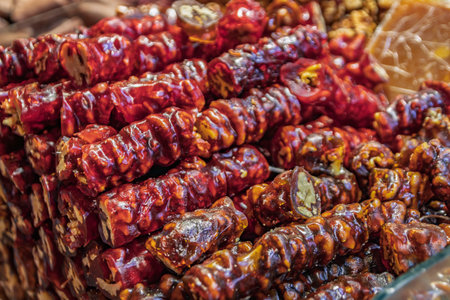 A pile of traditional churchkhela or cevizli sucuk, a string of walnuts dipped in grape juice on display at the Egyptian Bazaar, Istanbul, Turkeyの写真素材