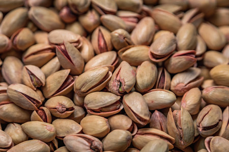 Fresh whole pistachios in shells on display for sale in bulk at a vibrant stall at the Egyptian...