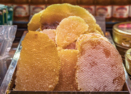 Golden raw honeycomb on display, natural texture and rich color, at a market stall at the Egyptian...
