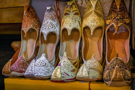 A colorful display of intricately embroidered pointed toe ottoman Turkish shoes, intricate gold and...