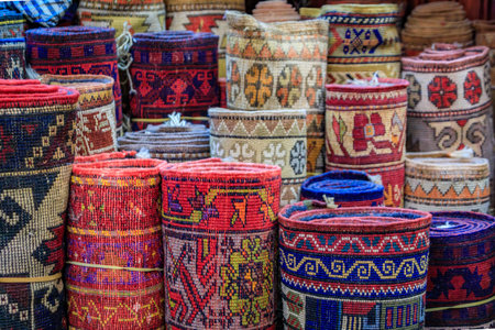 Traditional Turkish carpets or hali rugs with intricate patterns and vibrant colors displayed at a...