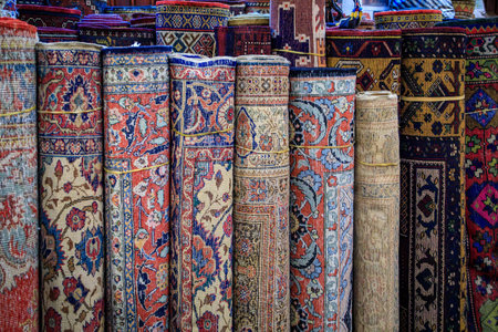 Traditional Turkish carpets or hali rugs with intricate patterns and vibrant colors displayed at a...