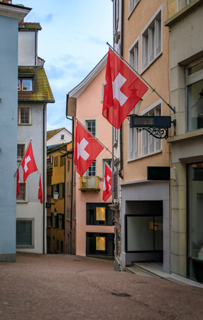 Rennweg, a famous cobblestone street with guild flags on historic landmark buildings in the Old Town Altstadt of Zurich, Switzerlandの写真素材