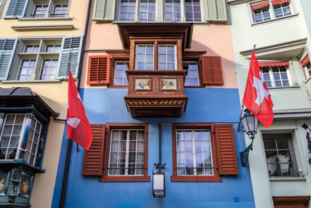 Swiss flags hang from the historic facades of traditional buildings in the Old Town Aldstadt on the...