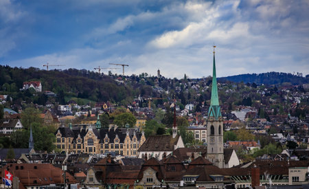 An aerial view of the city skyline with its historic buildings, prominent church spires, and...
